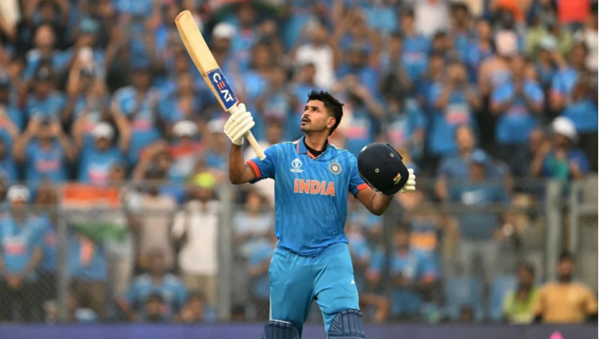Shreyas Iyer raises his bat after completing his century against New Zealand in the semi-final. (Pic: Getty)